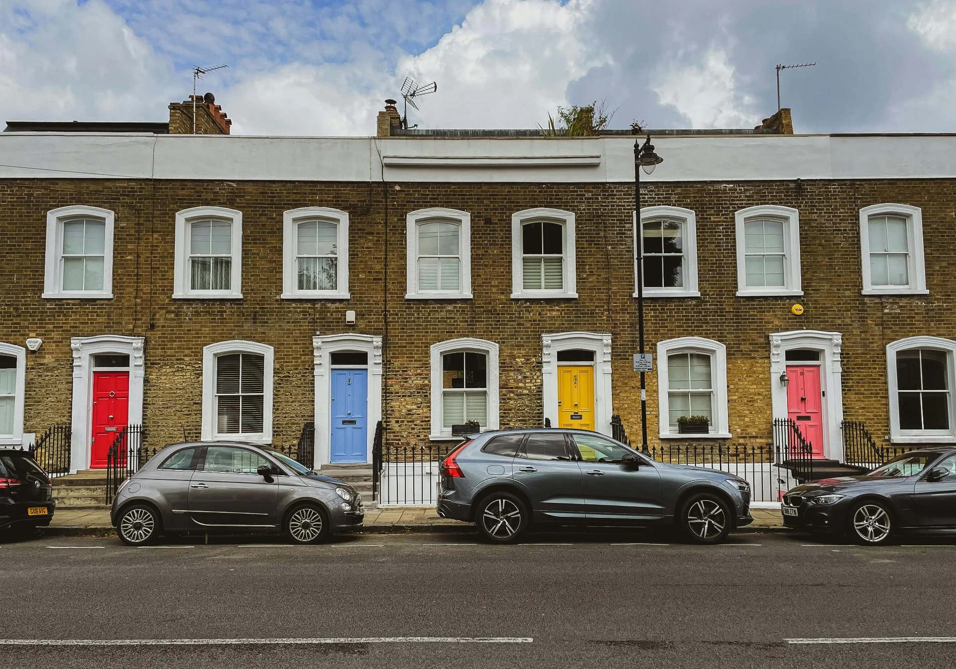 Row of terraced houses with colourful front doors on a London street