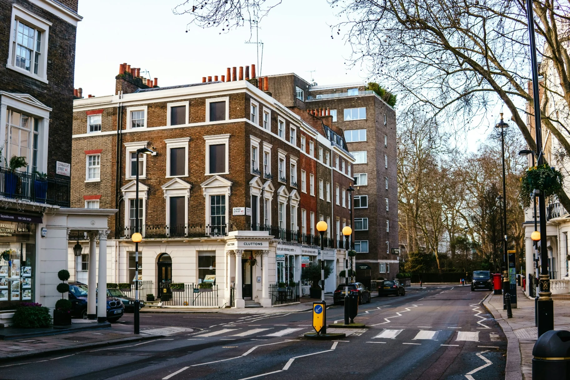 Period buildings on a tree-lined London street corner