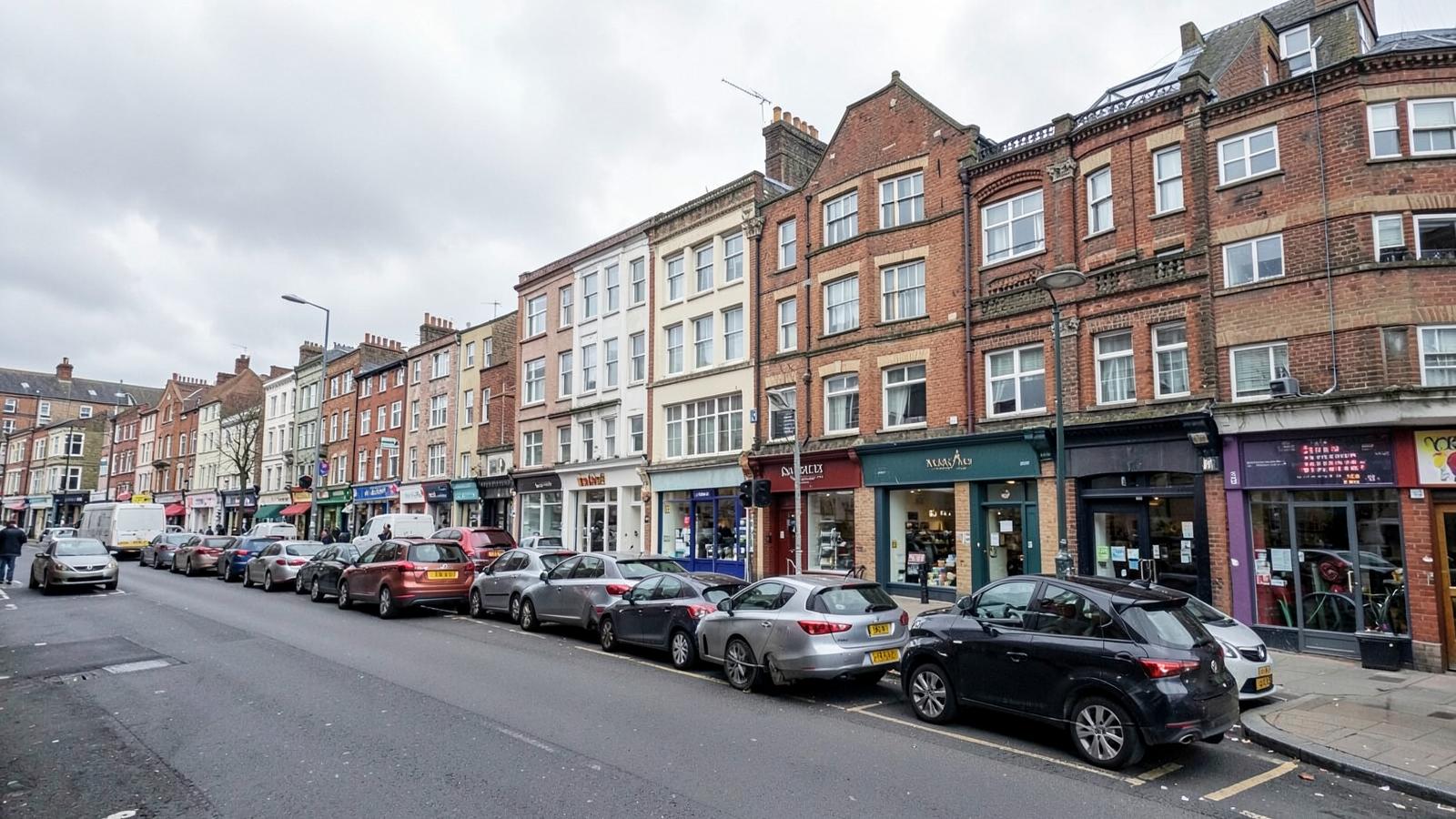 A parade of mixed-use British shops with residential flats on the upper floors